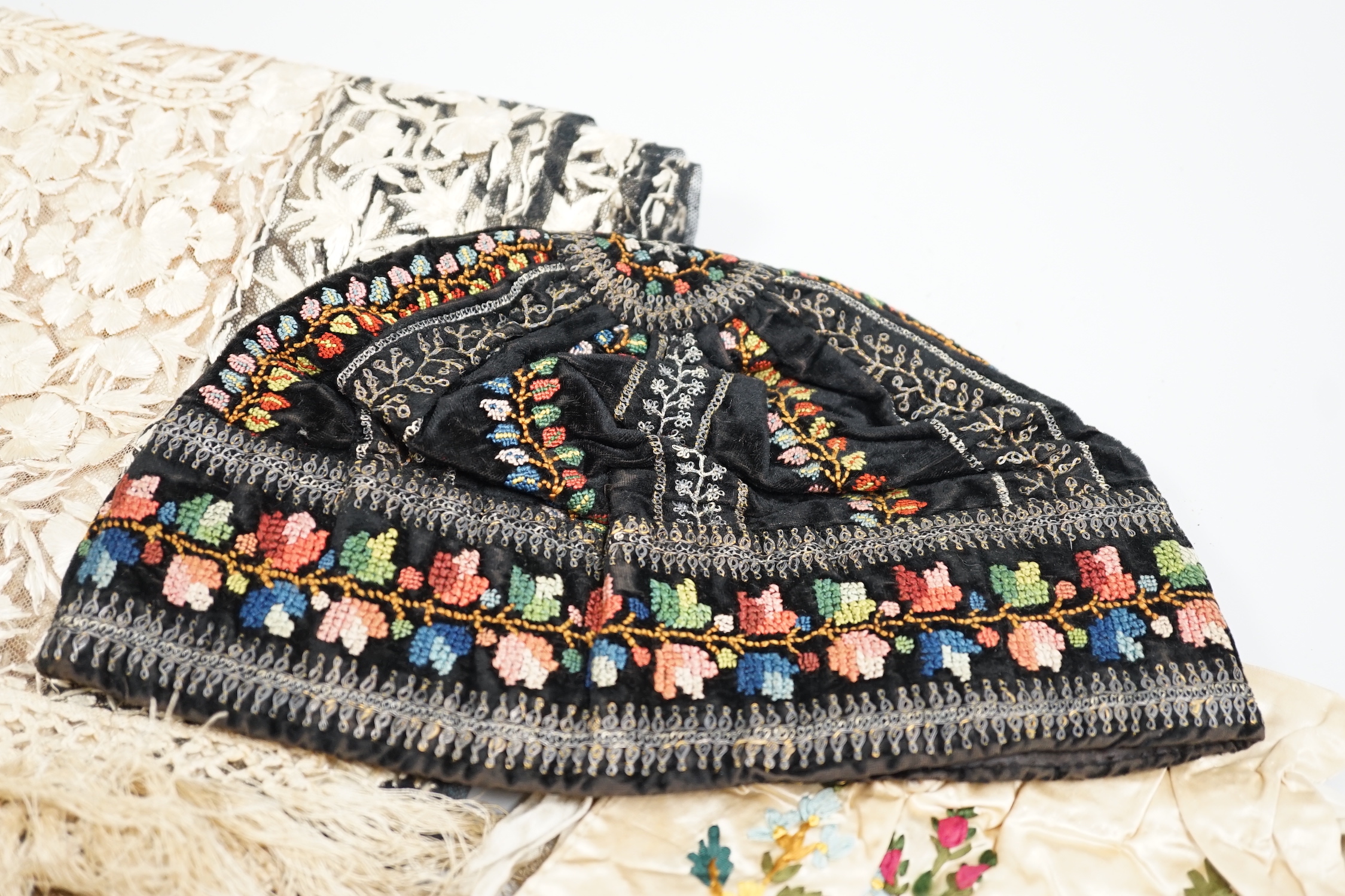 A 19th century Indian net embroidered silk floss stole, a black velvet silk cross stitch embroidered hat and a cream satin ribbon worked ladies bag, stole 240cm long, 57cm wide